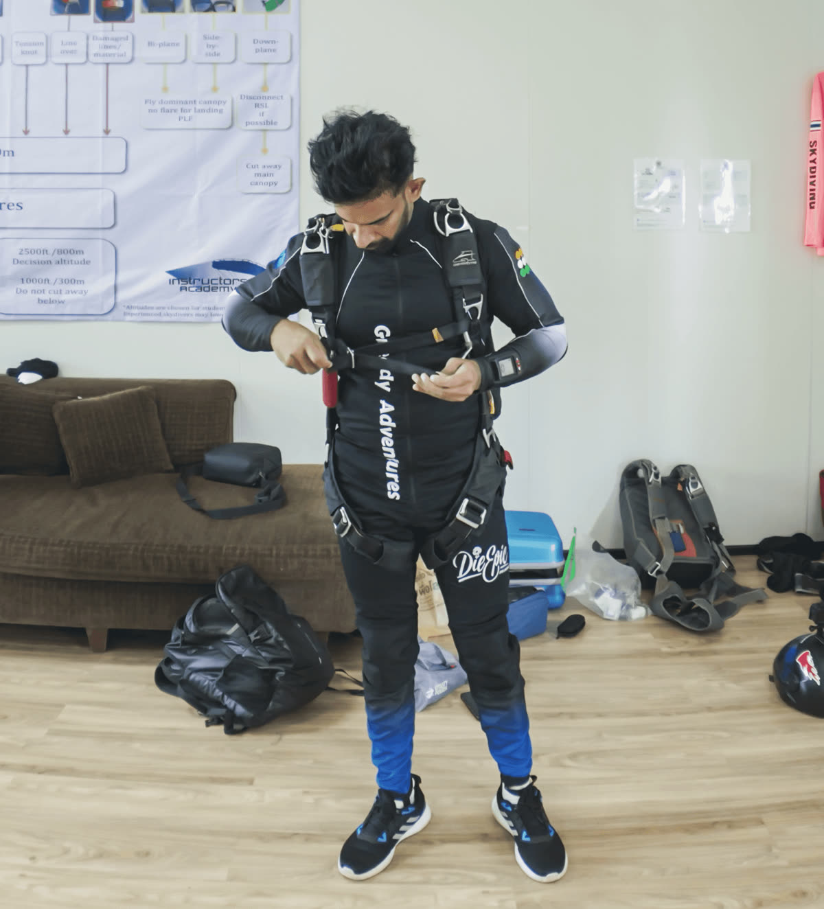 Licensed skydiver gearing up and checking equipment at dropzone